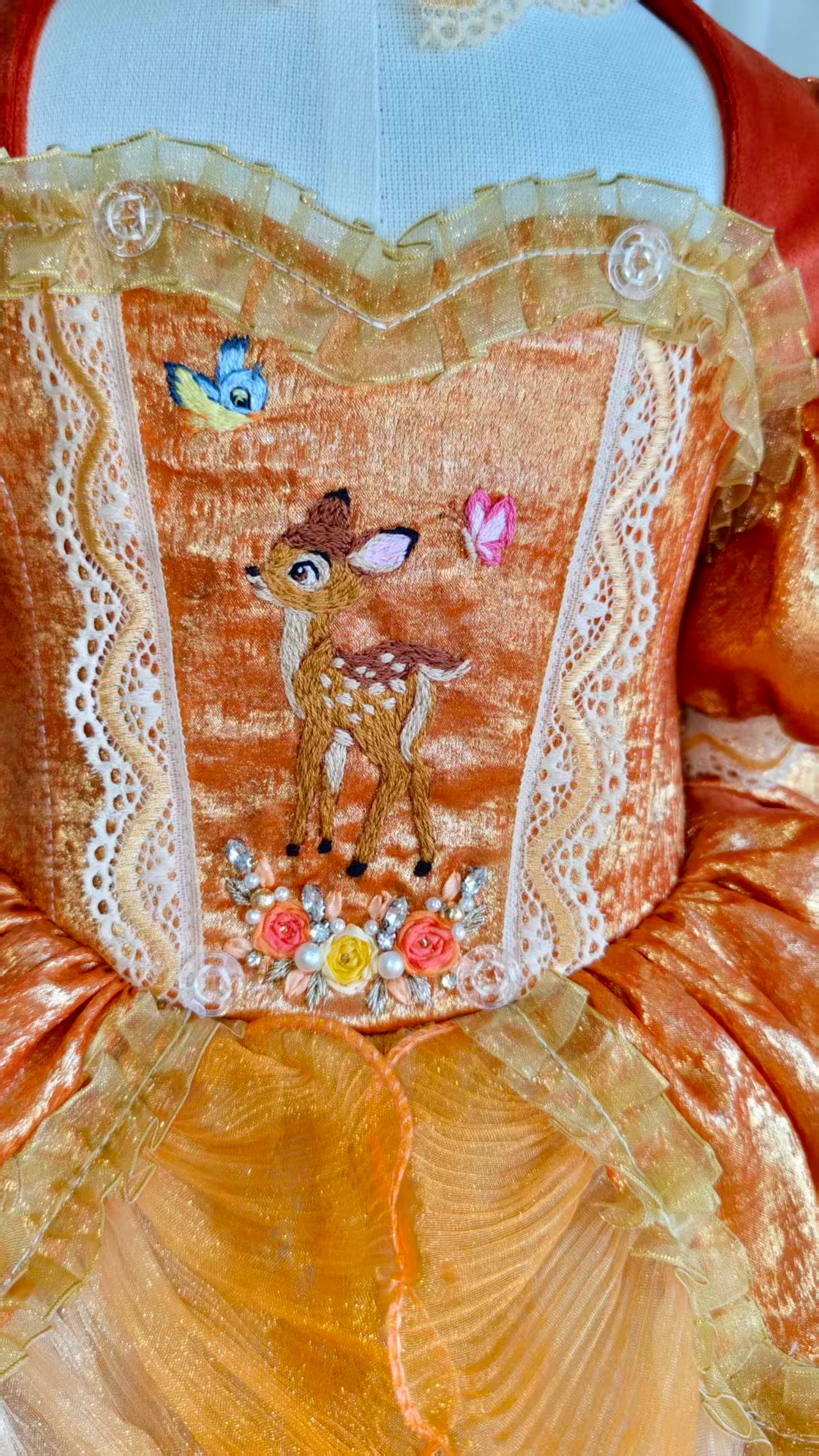 Dress on mannequin - close detail of hand-embroidered bodice panel
