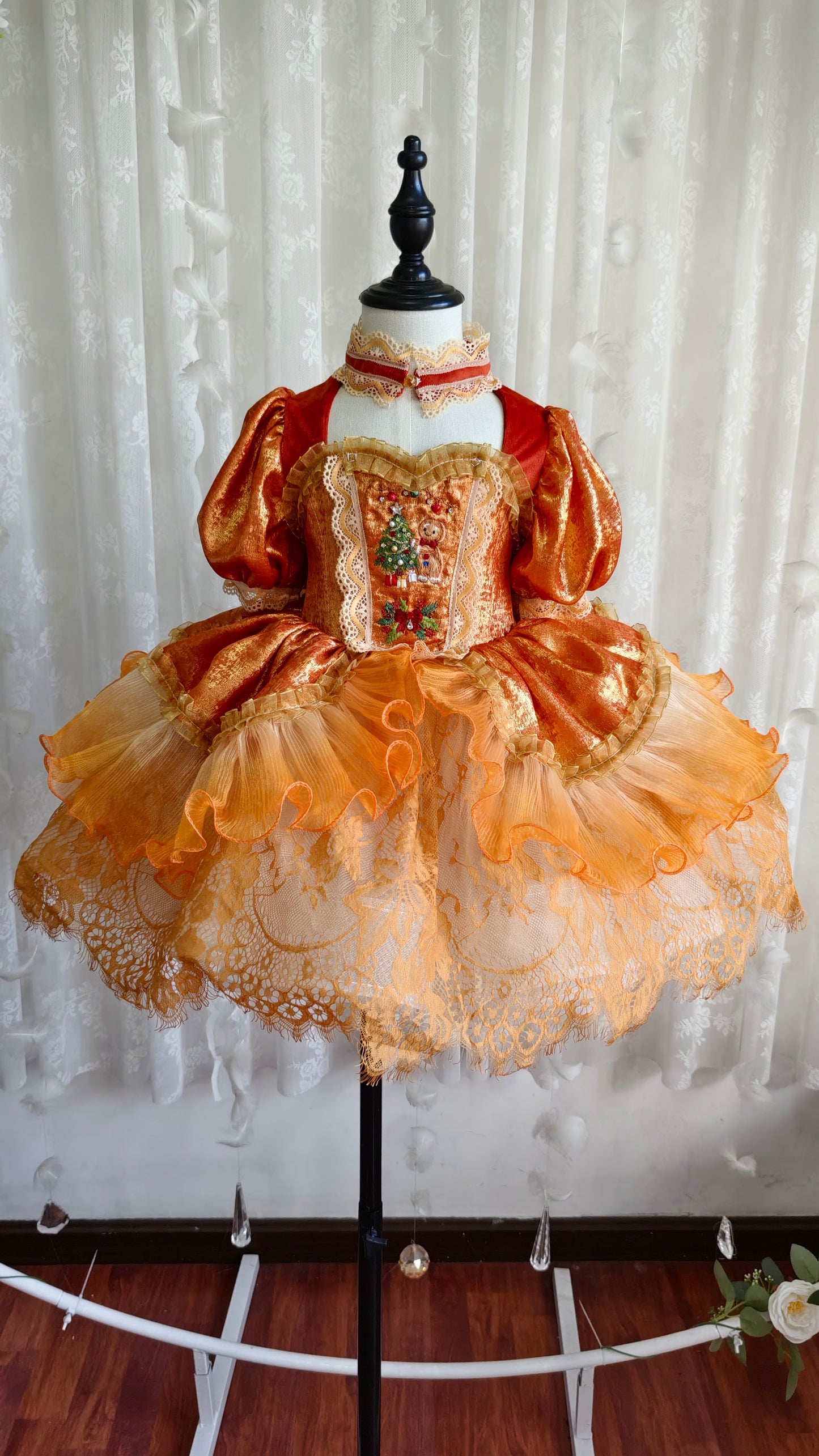 Dress on mannequin - front view showing embroidered panel and tiered skirt