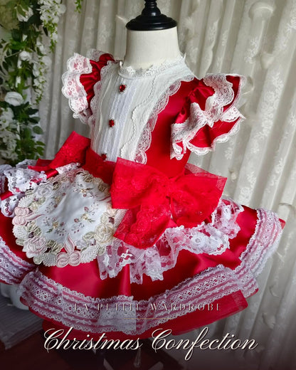 Side angle of the Christmas Confection dress showing the removable rose-embroidered apron
