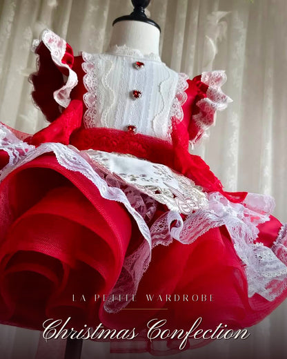 Close detail of the red taffeta skirt and ivory lace trim on the Christmas Confection dress